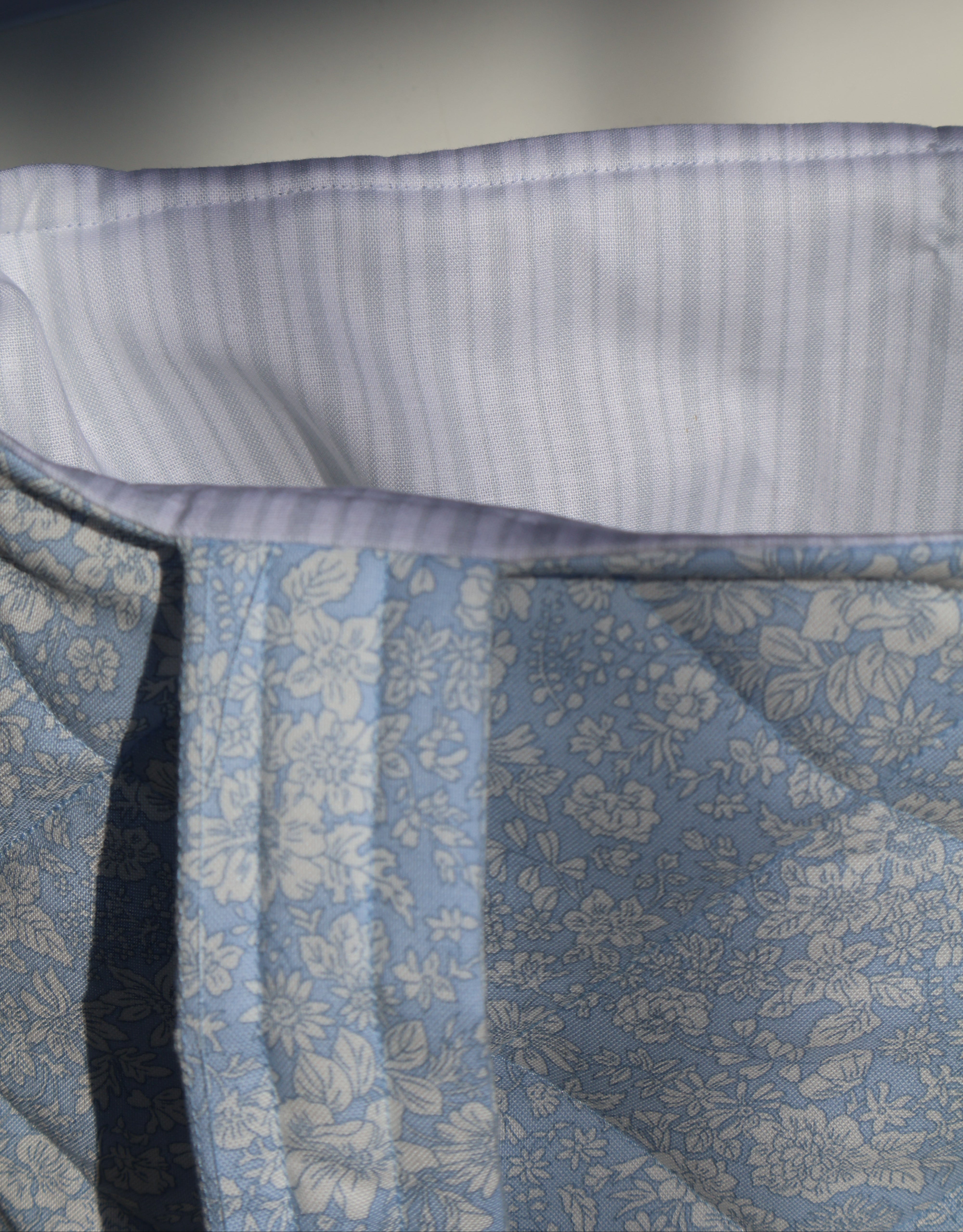 Close-up of a blue floral fabric with a white border