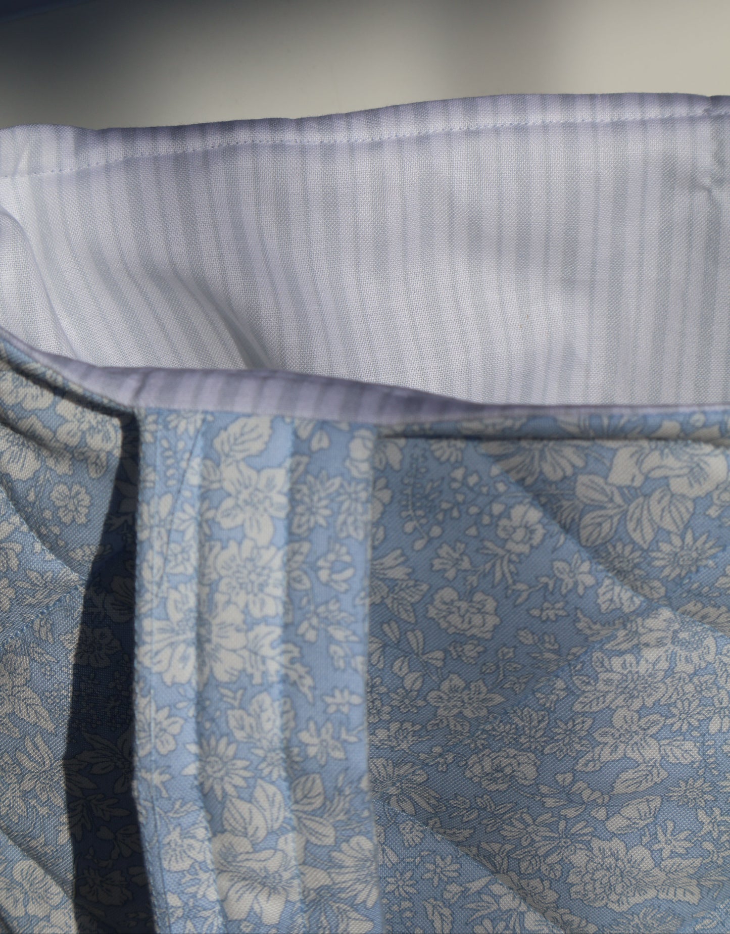 Close-up of a blue floral fabric with a white border